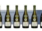 six bottles of wine are lined up on a table