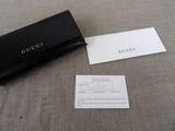 a black purse and a business card sitting on a table
