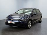 a blue volkswagen e - golf is parked in a large room