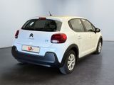 the back of a white citrole parked in a room