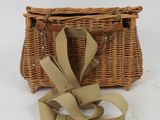 an image of a wicker purse with a ribbon tied around it