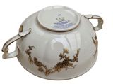 a white bowl with a gold design on it