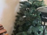 a small christmas tree next to a small christmas tree in a room