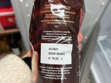 a person holding a bag of coffee in their hand