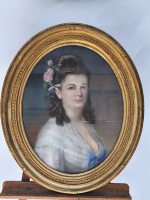 portrait of a woman in a blue dress with a flower in her hair