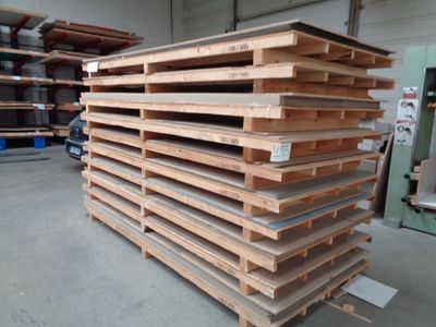 a large stack of wooden pallets in a warehouse
