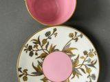 a close up of a cup and saucer on a table