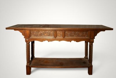 an old wooden table with two drawers and a shelf underneath it