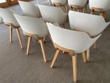 many white chairs that are sitting in a room