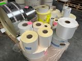 many rolls of paper on a pallet in a warehouse