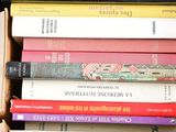 a box full of books that are stacked on top of each other