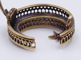 an image of a gold bracelet with a bird on top of it