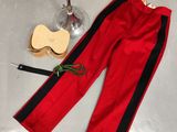 a red pants with black stripes and a glass of wine next to it