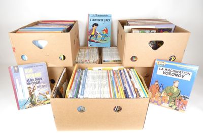 several boxes of children ' s books are stacked on top of each other