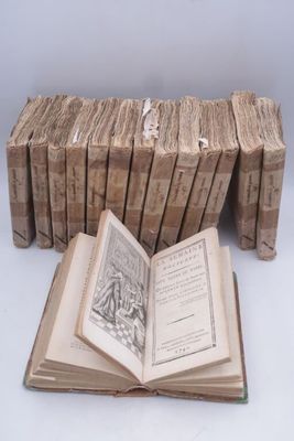 several old books are stacked on top of each other on a table