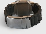 the watch is black and silver in color and has a metal band