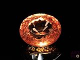 a large orange diamond sitting on top of a black surface