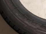 a close up of a tire on the ground next to a pair of scissors