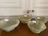 several bowls are sitting on a table with labels on them