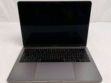 a laptop that is sitting on a white surface