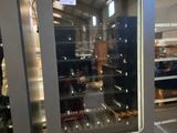a vending machine in a store with a glass door