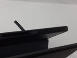 the back of a black laptop computer sitting on top of a white table