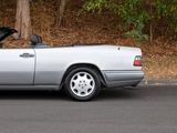 a silver convertible car parked on the side of the road
