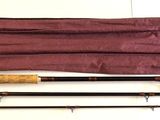 two rods and a bag on the floor next to each other