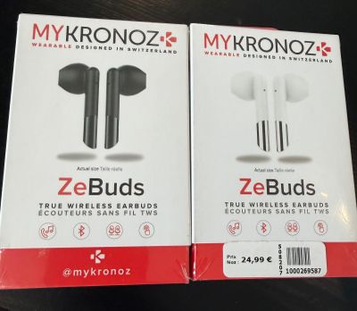 two boxes of ze buds ear buds sitting on top of a table
