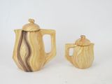 two wooden teapots and a coffee pot on a white background