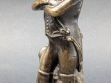 bronze figurine of a man with a hat and a sword