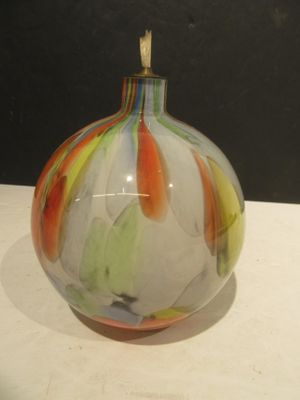a glass vase with a colorful design on it on a table