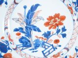 a blue and orange plate with a flower design on it