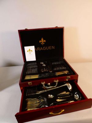 a wooden box with silverware in it on a table