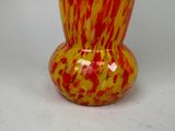 a vase that has a red and yellow design on it