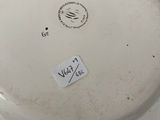 a white plate with a sticker on it on a table
