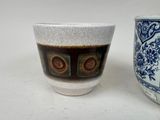 two cups sitting next to each other on a table