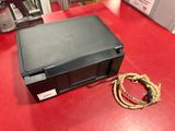 a black box on a red table with a rope