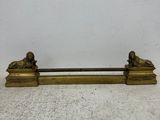 antique brass figurine of a lion and a lioness on a bench