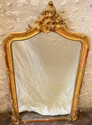 a mirror that is sitting on the floor in front of a wall
