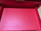 a red box that has a drawer inside of it