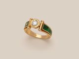 a gold ring with a green enamel band and a diamond