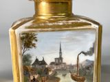 a small vase with a painting on it on a table
