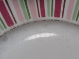 a white plate with pink and green stripes on it