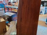 a tall wooden clock sitting on a table in a room