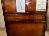 a brown chest of drawers with a price tag on it
