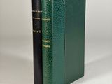 a green book with a black cover and a gold trim