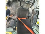 a view of the driver ' s seat and steering wheel of a bus