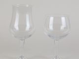 two empty wine glasses sitting next to each other on a table
