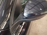 a side view mirror of a car in a showroom
